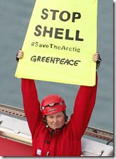 Actor Lucy Lawless and Greenpeace activists stop a Shell-contracted oil drillship leaving Port Taranaki, New Zealand and heading to the Arctic to start drilling for oil. They deploy banners which read ‘Stop Shell’ and ‘#SaveTheArctic’. Shell is positioning itself to be at the head of an oil-rush into the Arctic, in expectation that climate change will continue to drive up the average Arctic summer ice melt, and so make drilling in the region easier. Oil spills are virtually impossible to clean up in Arctic conditions. Activist Raroni Hammer also appears in the shot. 
